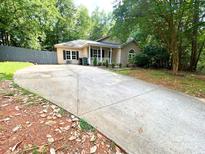 Charming one-story home featuring a spacious driveway and well-maintained landscaping at 3051 Dairy Farm Dr, Monroe, NC 28110
