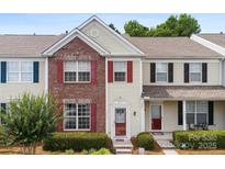 Charming townhome with brick facade, red shutters, and manicured landscaping at 3247 Mannington Dr, Charlotte, NC 28270