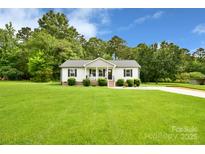 Charming single-story home featuring a well-manicured lawn and classic architectural details at 339 Brown Rd, China Grove, NC 28023