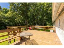 Spacious wooden deck perfect for outdoor entertaining with built-in benches and railing at 4330 Rowell Rd, Lancaster, SC 29720