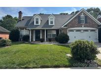 Charming brick home with a well-manicured lawn and a two-car garage at 5707 Sustar Dr, Monroe, NC 28110