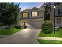 Charming two-story home with a well-manicured lawn and a two-car garage at 858 Rook Rd, Charlotte, NC 28216