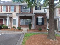 Charming townhome with brick facade, manicured landscaping, and inviting curb appeal at 8838 Wandering Creek Way, Charlotte, NC 28227