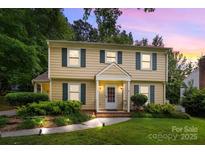 Charming two-story home featuring traditional architecture, a well-manicured lawn, and inviting front porch at 906 Wishing Well Ln, Charlotte, NC 28270