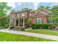 Charming two-story brick home featuring a columned front porch and manicured landscaping at 2004 Viscount Dr, Matthews, NC 28104
