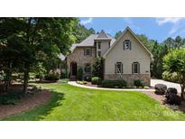 Charming stone and stucco home with manicured lawn and lush landscaping on a sunny day at 2590 Berne Ln, Sherrills Ford, NC 28673