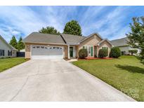 Charming single-story home with a well-manicured lawn and a two-car garage at 4321 Timberwood Dr, Gastonia, NC 28056