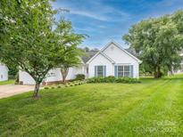 Charming single story home with blue shutters and a well-manicured lawn at 703 Bradberry Ln, Indian Trail, NC 28079