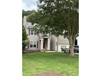 Charming two-story home with light brown siding, red shutters, well-manicured lawn, and attached two-car garage at 8618 Sam Dee Rd, Charlotte, NC 28215