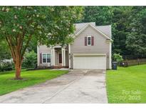 Charming home with a well-maintained lawn, attached two-car garage, and beautiful tree in the front yard at 8618 Sam Dee Rd, Charlotte, NC 28215