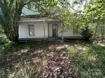Exterior of an older home with covered porch needing some TLC at 0 Woodleaf Rd, Salisbury, NC 28147