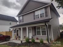 Charming two-story home with a covered front porch and well-maintained landscaping at 1017 W C St, Kannapolis, NC 28081
