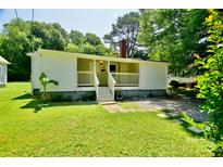 Charming one-story home with a cozy front porch and well-maintained lawn at 1020 N Ransom St, Gastonia, NC 28052