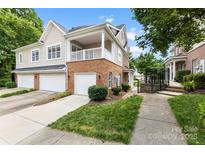 Charming townhome features a brick facade, covered porch, and attached garages at 15209 Loire Valley St, Charlotte, NC 28277