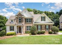 Charming brick and siding home with a well-manicured lawn and a picturesque blue sky. A beautiful two-story Gathering home at 1846 Sam Smith Rd, Fort Mill, SC 29708