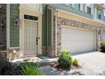 Inviting front door with brick accents and a well-maintained lawn at 3537 Hornets Nest Way # 206, Charlotte, NC 28208