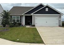 Charming single-Gathering home featuring a two-car garage, well-manicured lawn, and inviting curb appeal at 410 Apex Cir, Shelby, NC 28152