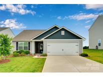 Charming single-story home with a well-manicured lawn and two-car garage at 410 Apex Cir, Shelby, NC 28152