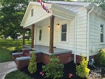 Charming home featuring a covered front porch with brick accents and well-manicured landscaping at 616 Laurel St, Albemarle, NC 28001