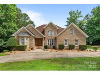 Charming brick home featuring manicured landscaping and a welcoming entrance at 8918 Beach Bluff Ct, Sherrills Ford, NC 28673