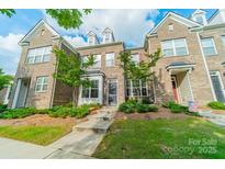 Charming brick townhome featuring well-maintained landscaping and inviting curb appeal at 11546 Red Rust Ln, Charlotte, NC 28277
