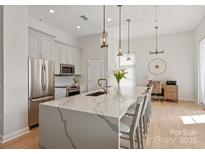 Bright kitchen with large island, stainless steel appliances, and stylish pendant lighting at 1315 East Blvd # 225, Charlotte, NC 28203