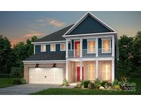 Inviting two-story home featuring a brick facade, upper level balcony, and a two-car garage at 1532 Gossage Nw Ln, Concord, NC 28027