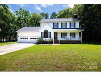 Charming two-story home featuring a two-car garage and a welcoming front porch at 1636 Springwinds Dr, Rock Hill, SC 29730