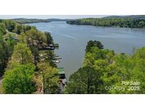 Beautiful aerial view of waterfront property surrounded by lush greenery and tranquil waters at 177 Mountain View Ln, Troy, NC 27371