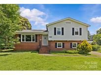 Charming two-story home with a brick facade, manicured lawn, and traditional architectural details at 2000 Townsend Ave, Charlotte, NC 28205