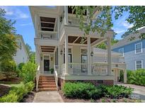 Charming home featuring a double porch, brick accents, and meticulous landscaping, enhancing its curb appeal at 202 Caldwell Ln, Davidson, NC 28036