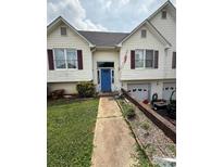 Charming house with a blue front door, attached garages and mature landscaping at 2056 Evergreen Dr, Newton, NC 28658