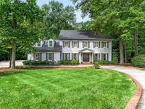 Charming two-story home with beautiful lawn, shutters and mature trees at 2141 Halford Pl, Charlotte, NC 28211