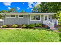 Charming single-story home with gray siding, white trim, and manicured landscaping in a lush green lawn at 411 Belvedere Cir, Kings Mountain, NC 28086