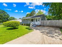 Charming single-story home with lush green lawn and a cozy front porch, perfect for relaxing and enjoying the outdoors at 411 Belvedere Cir, Kings Mountain, NC 28086
