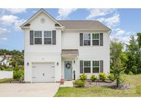 Charming two-story home with landscaped yard, covered entry, and attached garage, perfect for Gathering living at 1117 Laurel Woods Dr, Gastonia, NC 28052