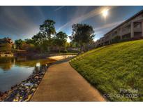 Beautiful waterfront community featuring manicured green space and private beach access with views of the lake at 14529 Waterside Dr, Charlotte, NC 28278