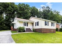 Charming ranch home with a brick foundation, lovely landscaping and a cozy front porch at 1617 Mulberry Cir, Rock Hill, SC 29732