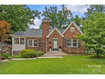 Charming brick home with well-maintained lawn, classic architectural details, and inviting entrance at 2005 Scott Ave, Charlotte, NC 28203