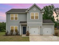 Two-story home featuring gray siding, an attached two-car garage, and a well-maintained front lawn at 2507 Waverly Dr, Monroe, NC 28112