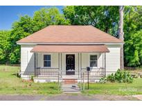 Charming bungalow featuring a welcoming porch and fenced front yard, perfect for curb appeal at 514 Jones St, Chester, SC 29706