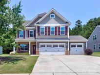 Charming two-story home with a three-car garage and well-maintained landscaping at 5797 Mcclintock Dr, Denver, NC 28037