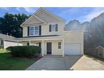 Charming two-story home features a well-manicured lawn, attached garage, and welcoming front porch at 745 Erin Brook Ct, York, SC 29745