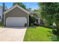 Charming home featuring a two-car garage and manicured lawn, presenting a welcoming curb appeal at 10043 Elsenham Ln, Charlotte, NC 28269