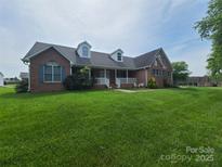 Charming single-Gathering home with a well-manicured front lawn, dormer windows, and a cozy front porch at 110 Kimberly Ln, Kings Mountain, NC 28086