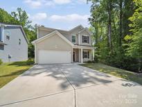 Inviting two-story home with a spacious driveway and well-maintained lawn at 125 Fosters Glen Pl, Mooresville, NC 28115