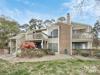 Charming multi-level townhouse with brick accents, balconies, and mature landscaping at 1600 Sharon W Rd # 16, Charlotte, NC 28210