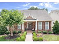 Charming single-story home featuring stone accents, manicured landscaping, and a welcoming front porch at 18236 Coulter Pkwy, Cornelius, NC 28031