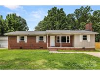 Charming brick home with a well-maintained front yard, neutral shutters, and a classic chimney at 2476 Cane Mill Rd, Lancaster, SC 29720