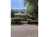 Charming two-story home with brick facade, white trim, and landscaped front yard at 317 Campus St, Charlotte, NC 28216
